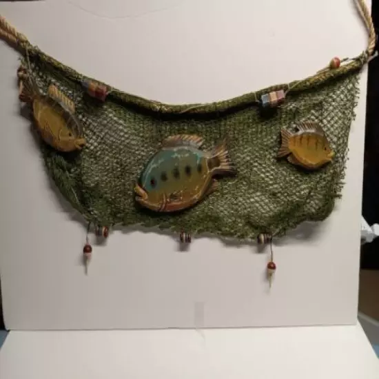 Green fish net with wooden fish and bobbers