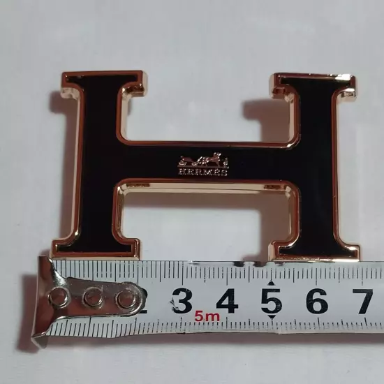 HERMES. Belt buckle with "HERMES" inscription. Gold-black tone. 