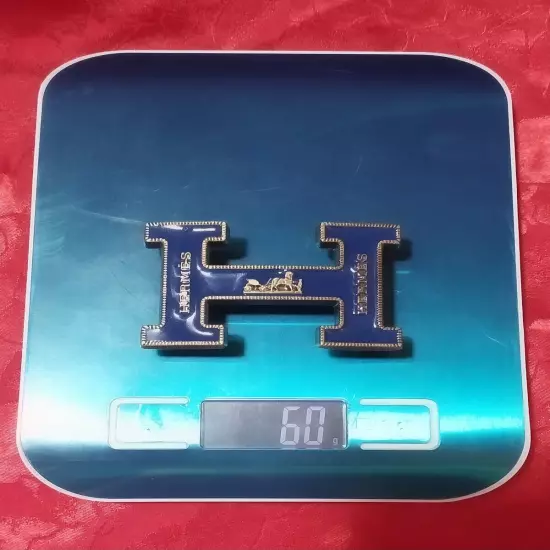 HERMES. Belt buckle with "HERMES" inscription. Gold-blue tone. 