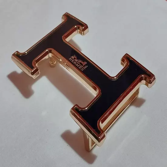 HERMES. Belt buckle with "HERMES" inscription. Gold-black tone. 