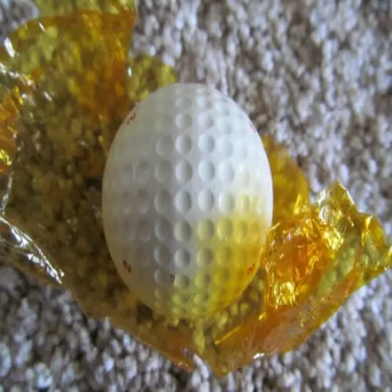 VINTAGE PARTIALLY WRAPPED XL DIMPLE GOLF BALL WITH MULTI MARKING