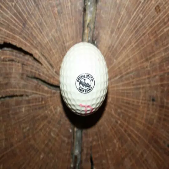 VINTAGE RED AND WHITE PING GOLF BALL WITH PEBBLE BEACH LOGO