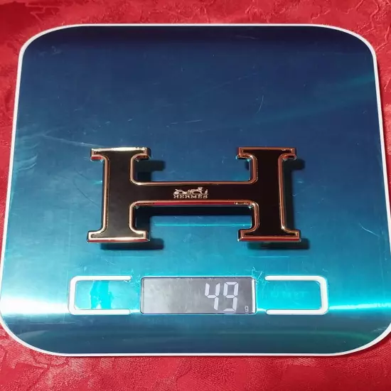 HERMES. Belt buckle with "HERMES" inscription. Gold-black tone. 