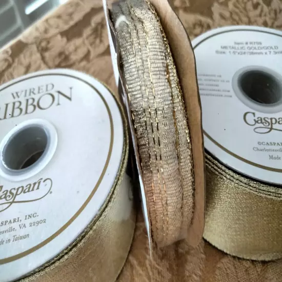  2 ROLLS OF CASPARI GOLD METALLIC RIBBON & ONE SMALL ROLL.