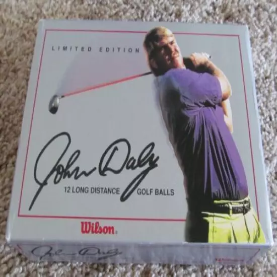 1 DOZEN JOHN DALY GOLF BALLS, 4 SLEEVES AND A DOZEN BOX. 1 BALL IS SLIGHTLY USED