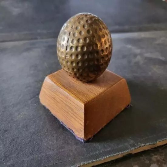 VINTAGE BRASS GOLF BALL PAPERWEIGHT MOUNTED ON WOOD