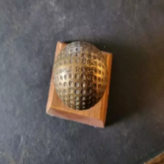 VINTAGE BRASS GOLF BALL PAPERWEIGHT MOUNTED ON WOOD