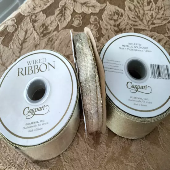  2 ROLLS OF CASPARI GOLD METALLIC RIBBON & ONE SMALL ROLL.