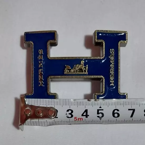 HERMES. Belt buckle with "HERMES" inscription. Gold-blue tone. 