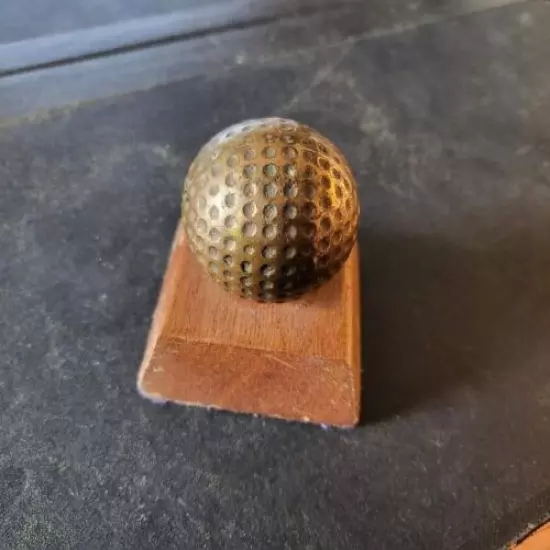 VINTAGE BRASS GOLF BALL PAPERWEIGHT MOUNTED ON WOOD