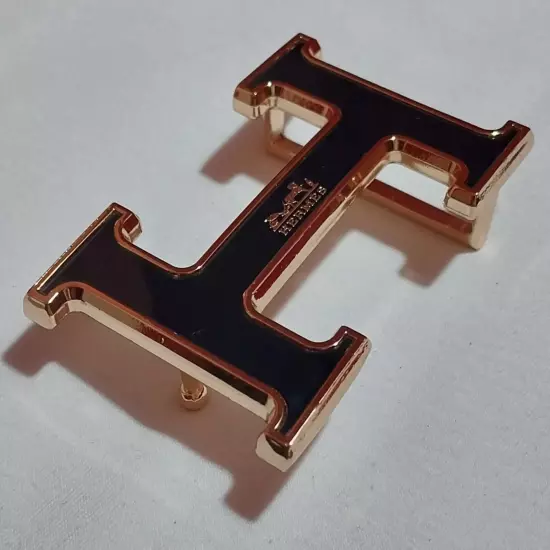 HERMES. Belt buckle with "HERMES" inscription. Gold-black tone. 