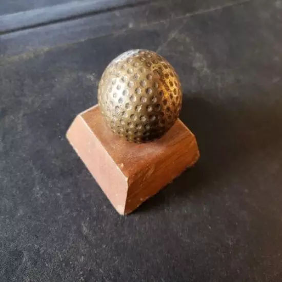 VINTAGE BRASS GOLF BALL PAPERWEIGHT MOUNTED ON WOOD