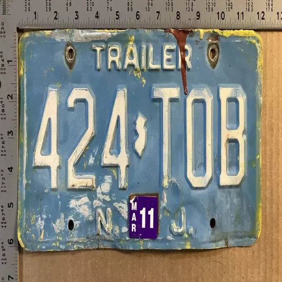 2011 New Jersey trailer license plate 424-TOB somewhat BASHED IN 15025