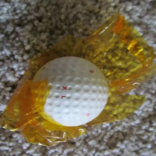 VINTAGE PARTIALLY WRAPPED XL DIMPLE GOLF BALL WITH MULTI MARKING