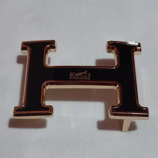 HERMES. Belt buckle with "HERMES" inscription. Gold-black tone. 