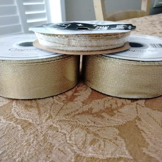  2 ROLLS OF CASPARI GOLD METALLIC RIBBON & ONE SMALL ROLL.