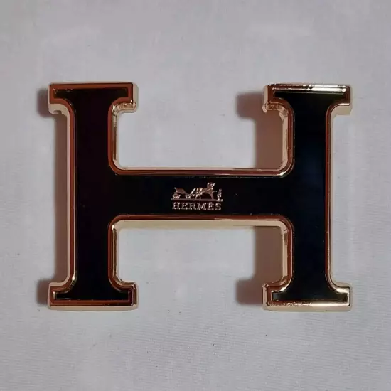 HERMES. Belt buckle with "HERMES" inscription. Gold-black tone. 